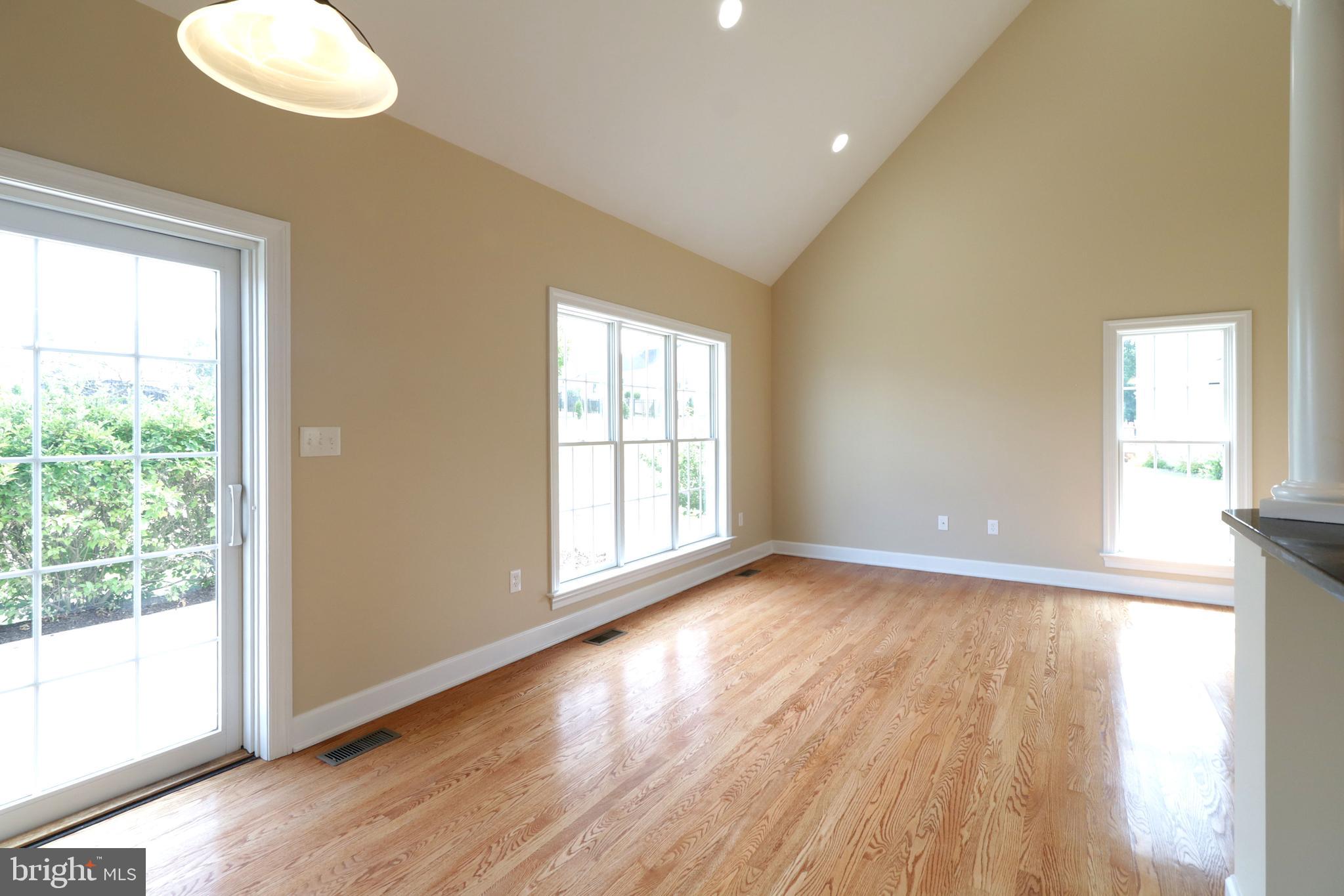 135 Fernleaf Court State College, PA 16801 - Photo 20 of 53 a view of an empty room with wooden floor and a window
