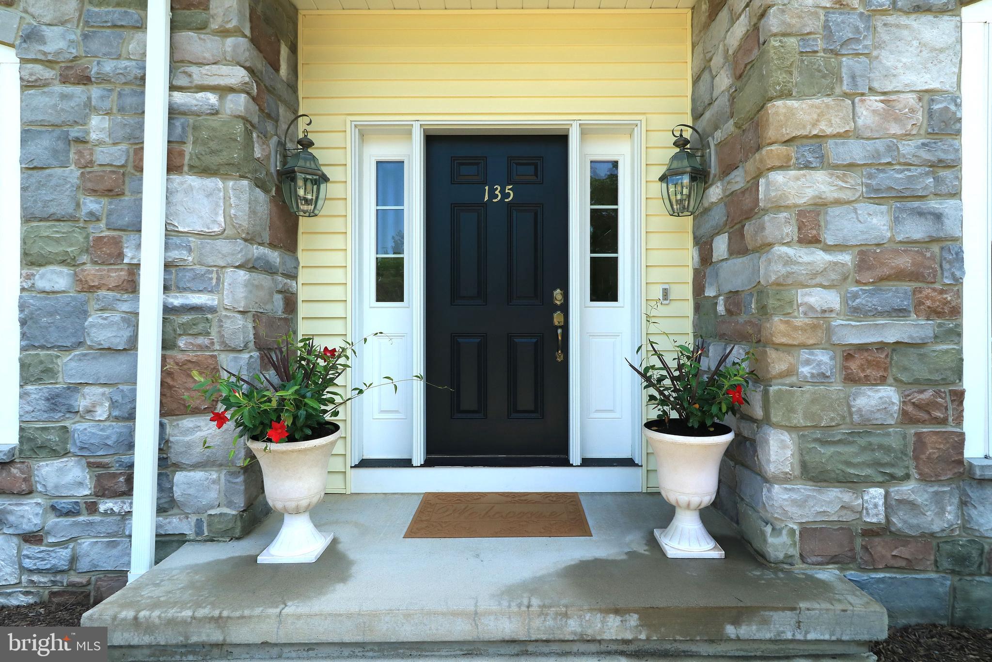 135 Fernleaf Court State College, PA 16801 - Photo 2 of 53 a view of a door of the house with potted plants