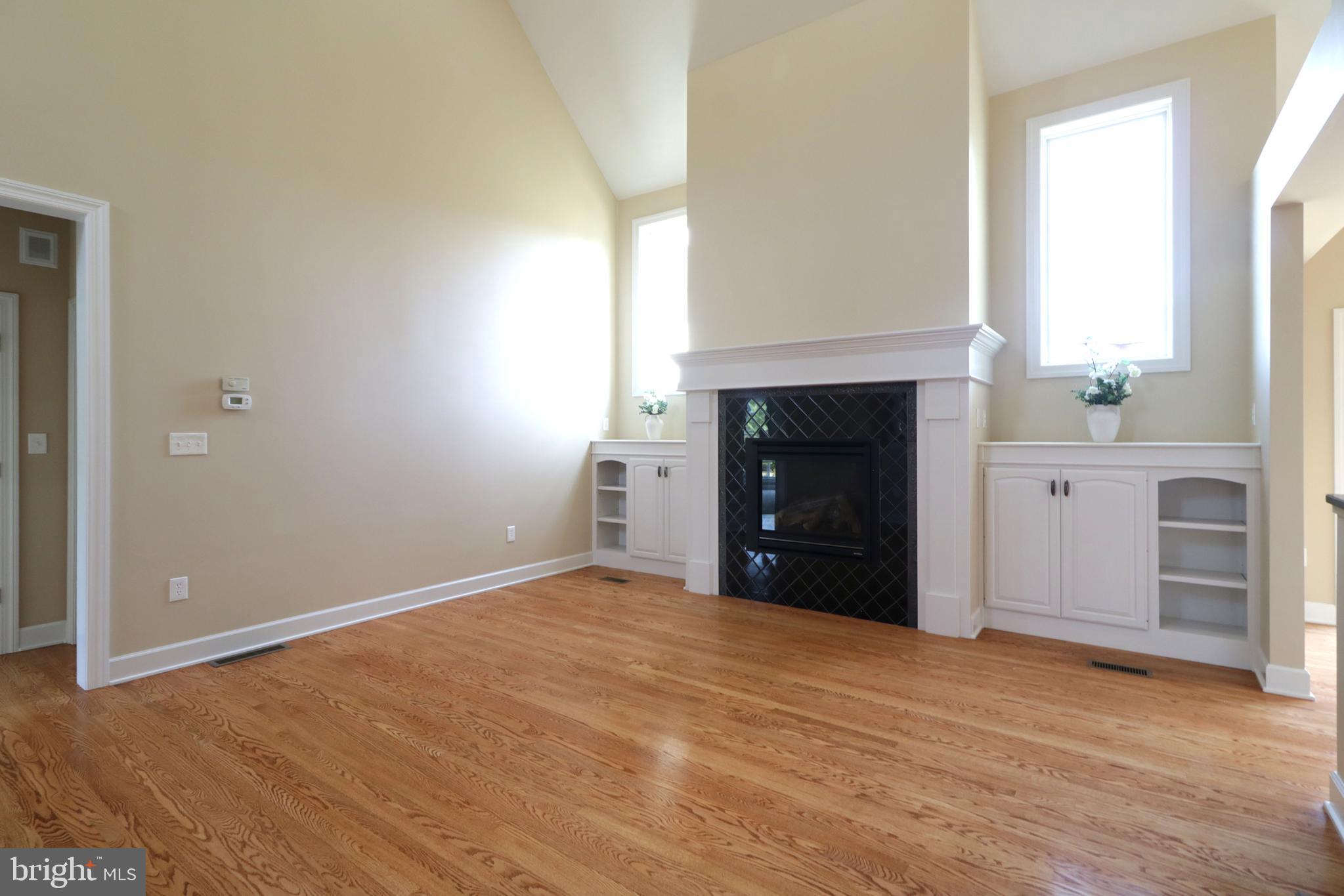 135 Fernleaf Court State College, PA 16801 - Photo 22 of 53 a view of an empty room with a fireplace and a window