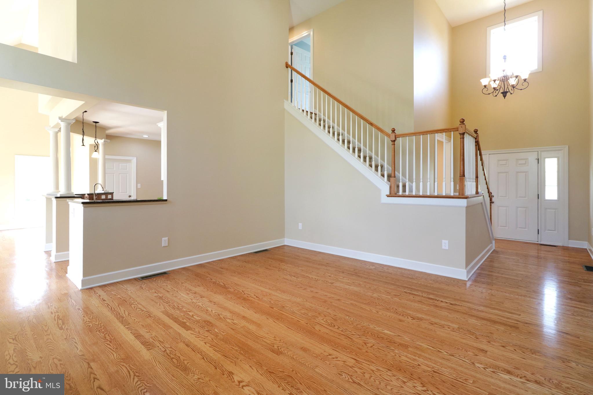 135 Fernleaf Court State College, PA 16801 - Photo 23 of 53 a view of an empty room with wooden floor and a window