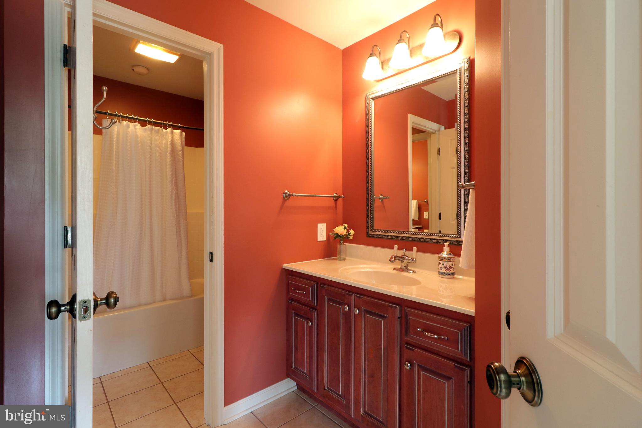 135 Fernleaf Court State College, PA 16801 - Photo 40 of 53 a bathroom with a double vanity sink and mirror