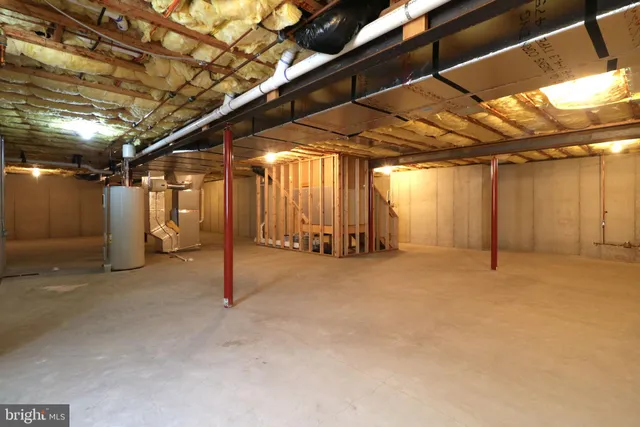 a view of a house with potted plants and couches chairs