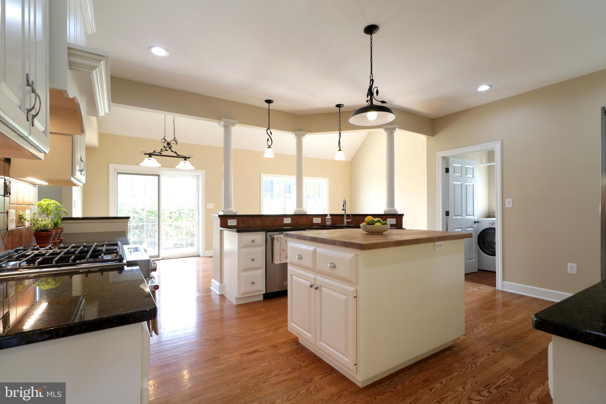 135 Fernleaf Court State College, PA 16801 - Photo 10 of 53 a kitchen with kitchen island a counter top space a sink a refrigerator and a view of living room
