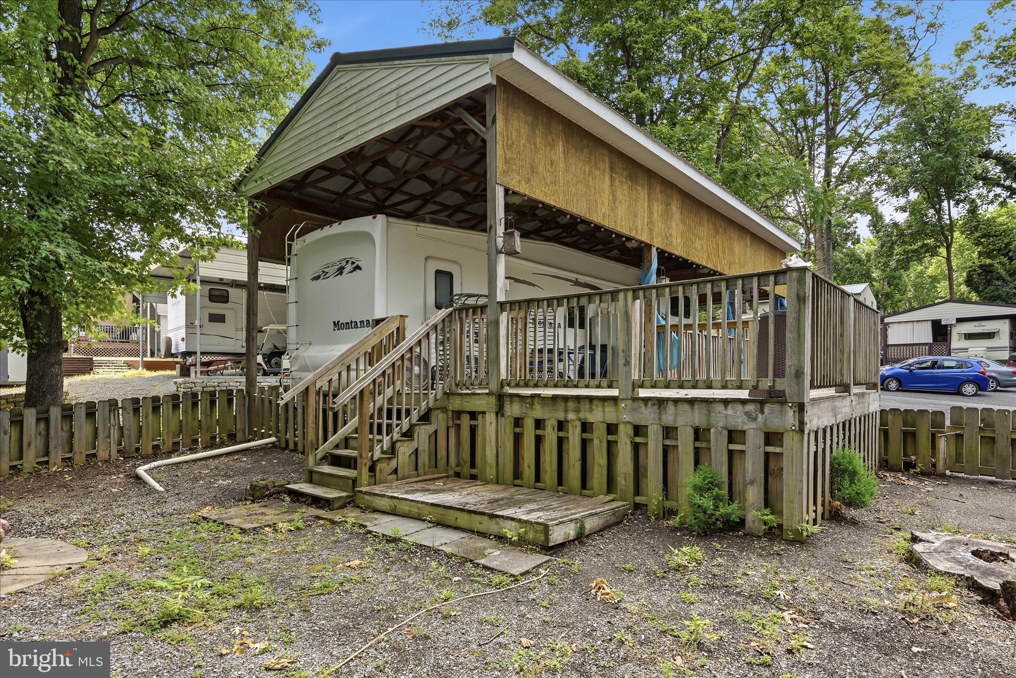 Lot 20 Hot Dog Road Falling Waters, WV 25419 - Photo 20 of 26 a view of a house with a wooden deck and a trees