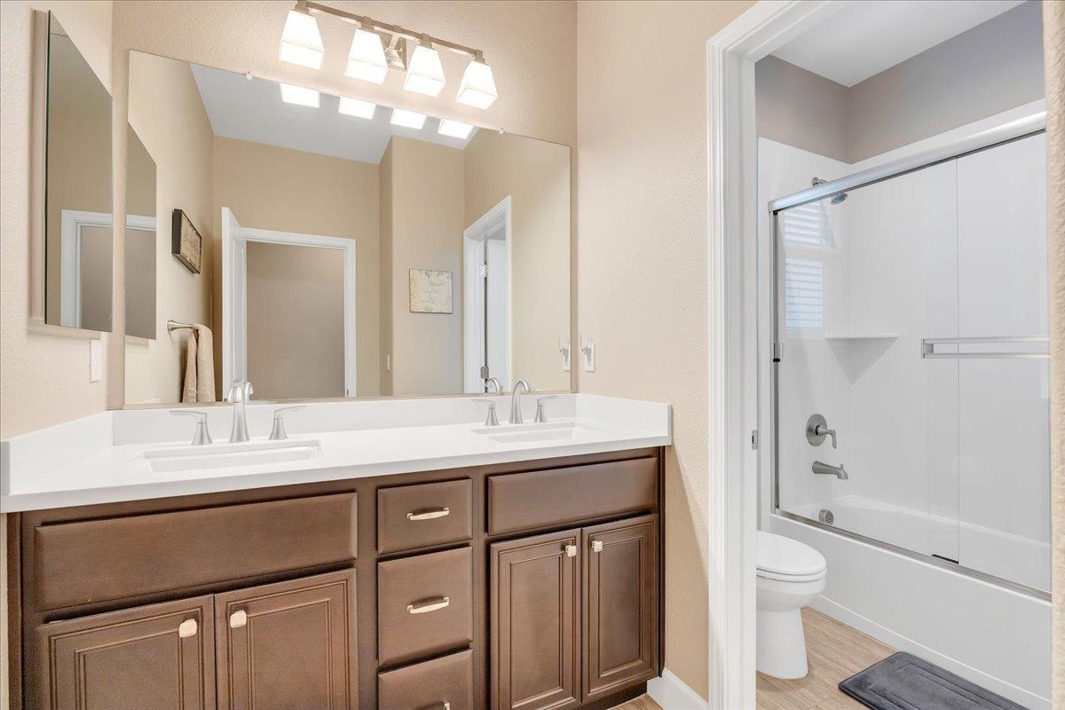 133 Palisades Place Copperopolis, CA 95228 - Photo 70 of 95 a bathroom with a granite countertop sink toilet a large mirror a vanity and shower