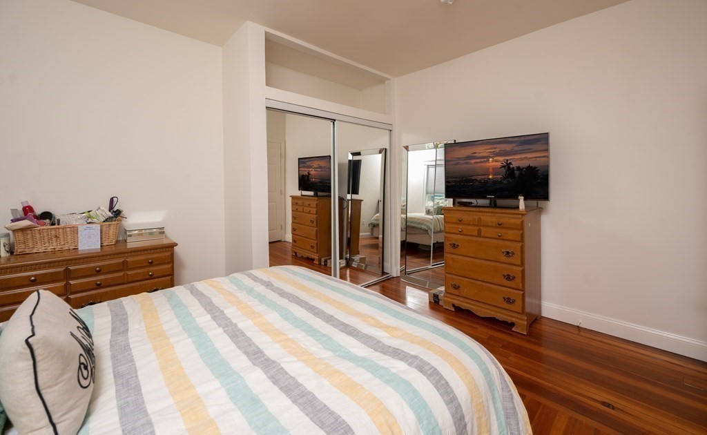 12 Thelma Road, Unit 3 Boston, MA 02122 - Photo 14 of 18 a bedroom with a bed and a flat screen tv