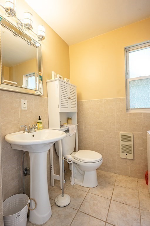 12 Thelma Road, Unit 3 Boston, MA 02122 - Photo 15 of 18 a bathroom with a sink a toilet and mirror