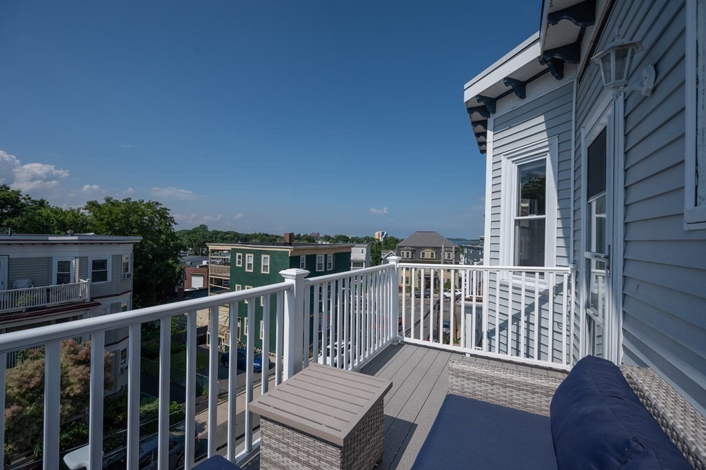 12 Thelma Road, Unit 3 Boston, MA 02122 - Photo 17 of 18 a view of a roof deck with wooden fence and floor