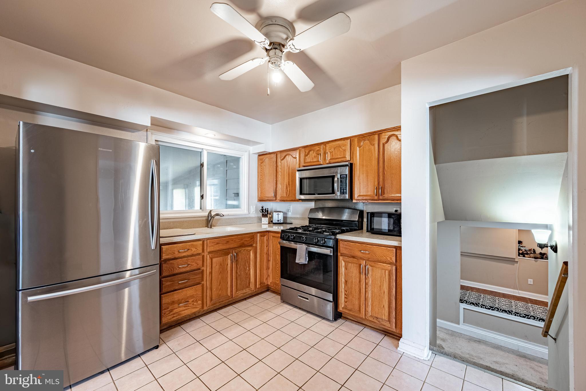 3621 Washington Avenue Baltimore, MD 21244 - Photo 12 of 25 a kitchen with stainless steel appliances granite countertop a refrigerator and a stove top oven