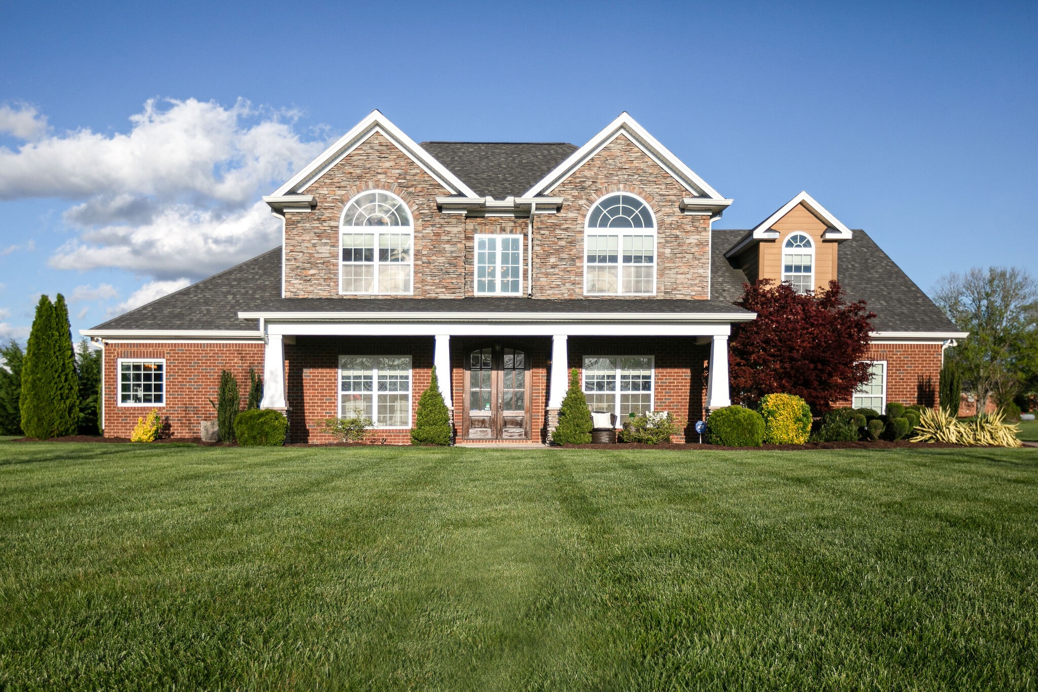 a front view of a house with a yard