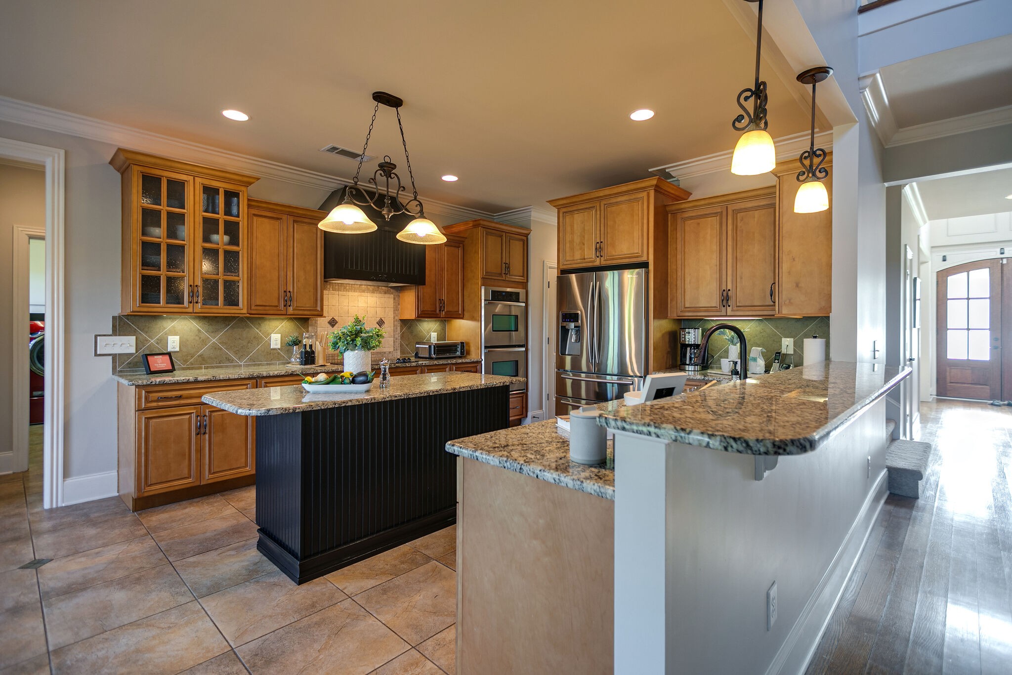 2104 Berry Patch Road Thompson's Station, TN 37064 - Photo 19 of 50 a kitchen with stainless steel appliances granite countertop a stove a sink and a refrigerator