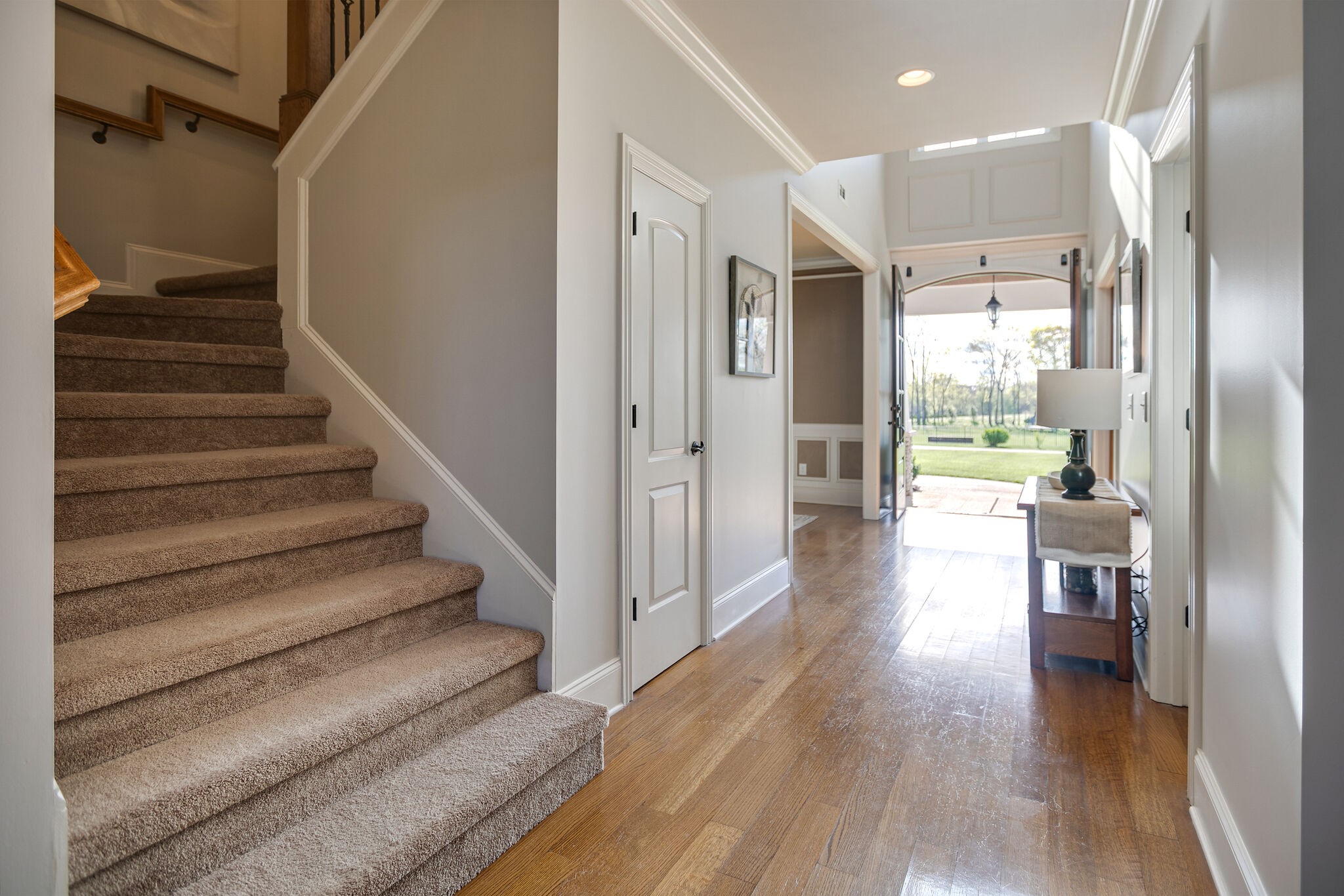 2104 Berry Patch Road Thompson's Station, TN 37064 - Photo 6 of 50 a view of a hallway with wooden floor and a kitchen view