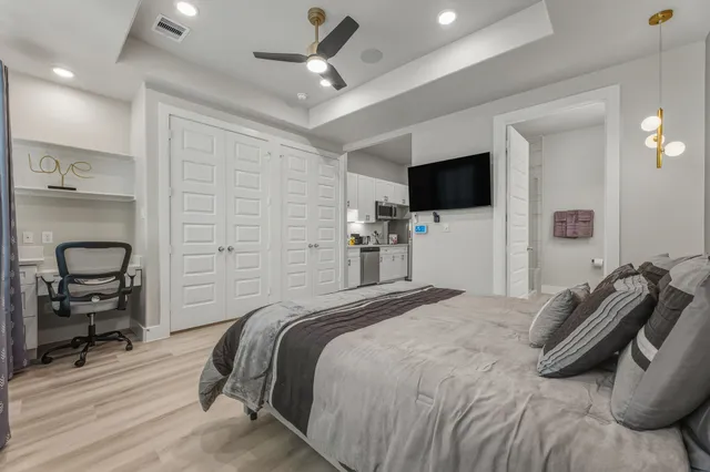 a bedroom with a bed and a flat screen tv