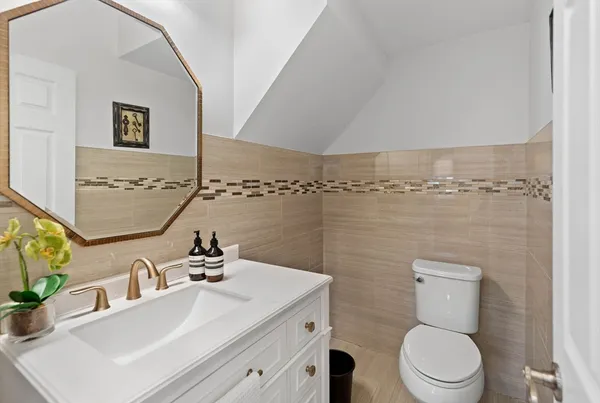 a bathroom with a sink a toilet and mirror