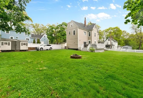 a view of a house with a yard and sitting area