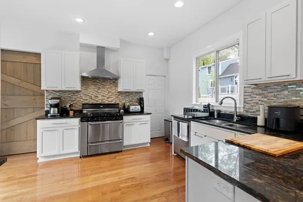 a kitchen with stainless steel appliances granite countertop a stove a sink and a granite counter tops