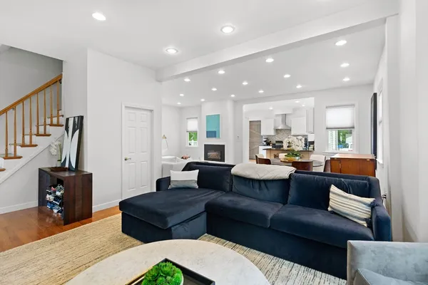 a living room with furniture and a wooden floor