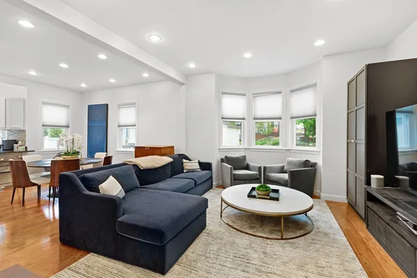a living room with furniture a window and a flat screen tv
