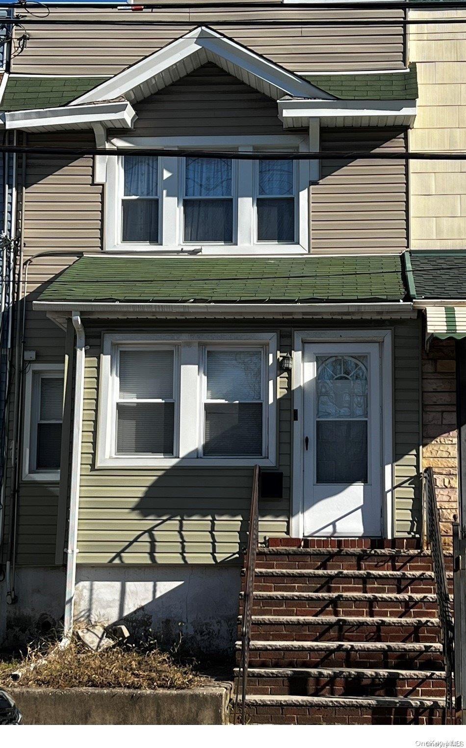 92-49 75th Street Queens, NY 11421 - Photo 1 of 1 a front view of a house