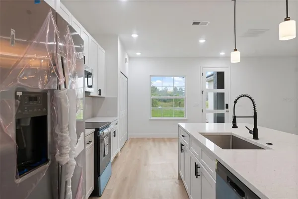 a kitchen with a sink and a refrigerator