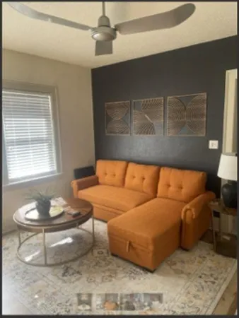 a living room with furniture and a window