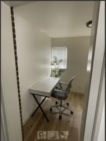 a view of a room that has a table and chairs in it