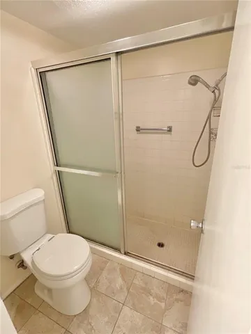a bathroom with a toilet and a shower