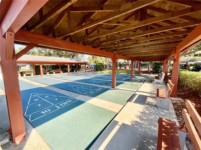 a living room with lots of chairs and a dining table with kitchen view