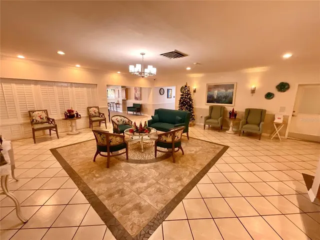 a lobby with furniture and a potted plant
