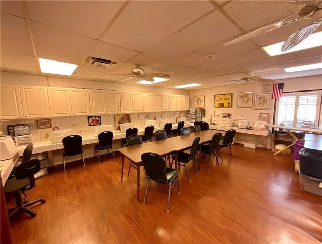 a room with pool table flat screen tv and windows