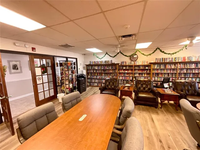 a group of people sitting in a room with chairs