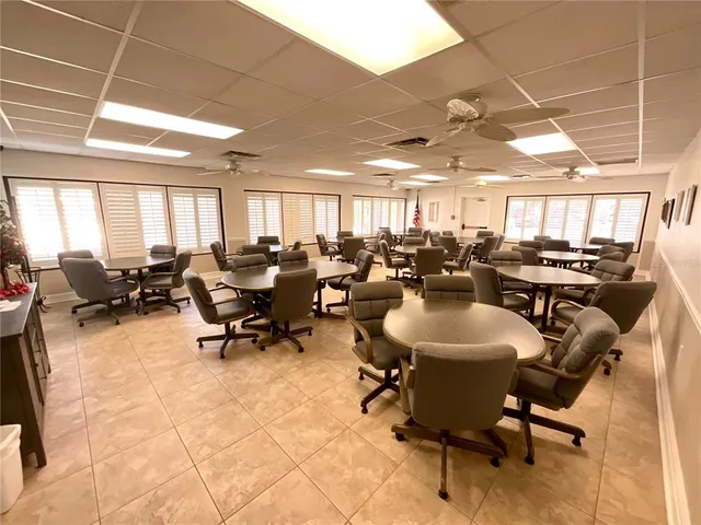 a room with pool table and a wooden floor