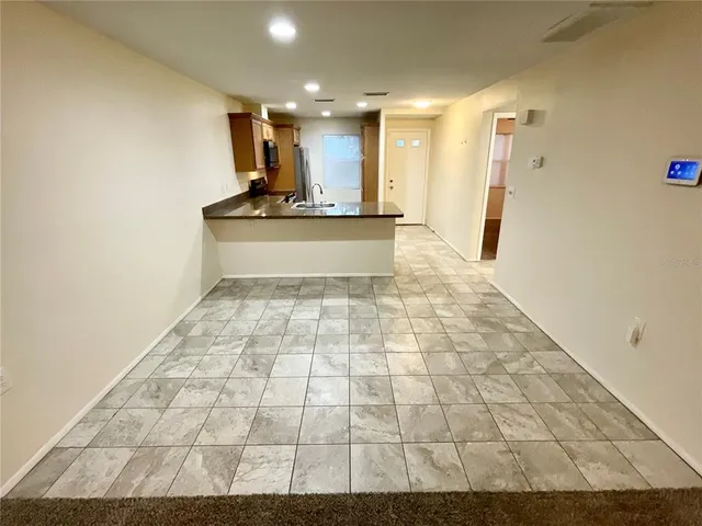 a view of a hallway with wooden floor and a large window