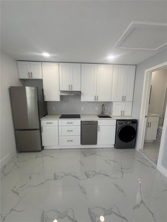 1524 Windermere Road, Unit B Winter Garden, FL 34787 - Photo 2 of 8 a kitchen with stainless steel appliances a refrigerator sink and cabinets