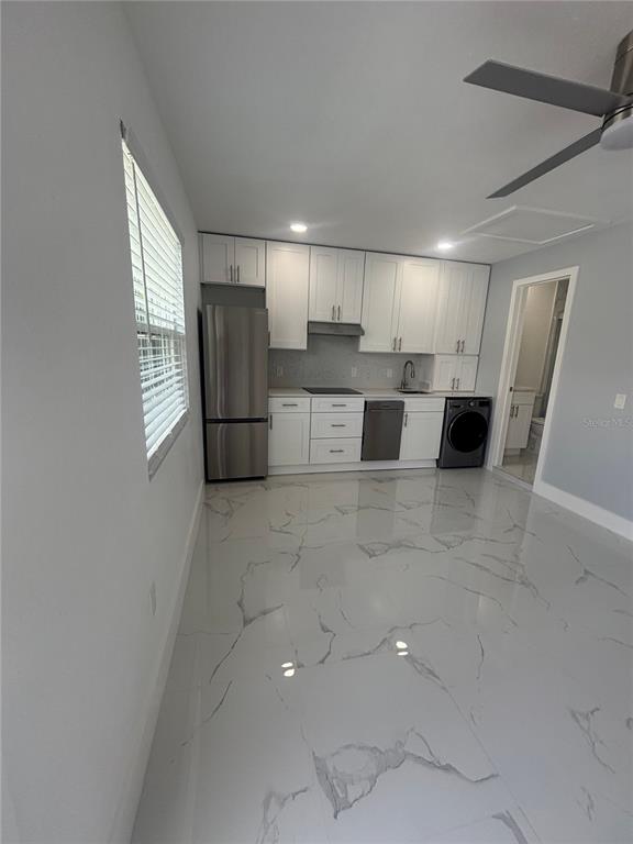 1524 Windermere Road, Unit B Winter Garden, FL 34787 - Photo 4 of 8 a living room with stainless steel appliances kitchen island granite countertop a refrigerator and a sink