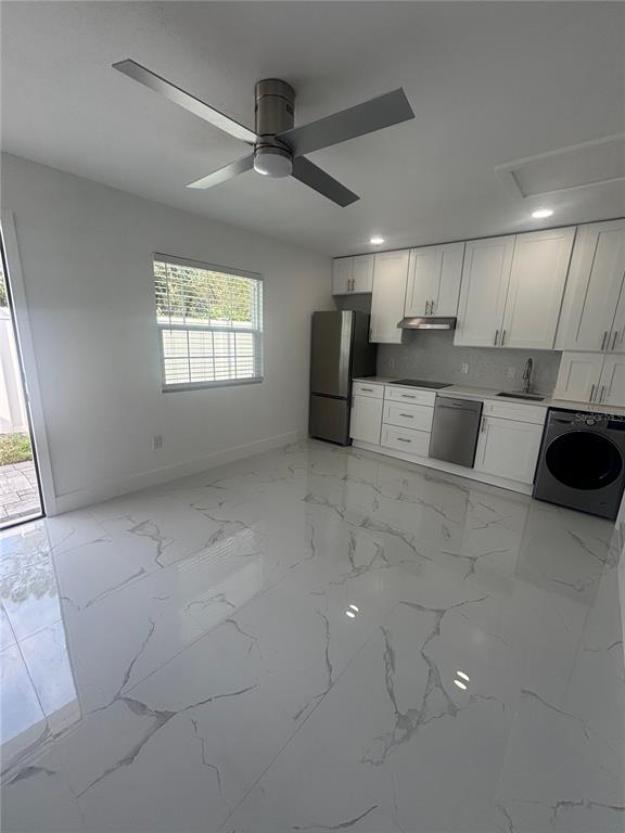 1524 Windermere Road, Unit B Winter Garden, FL 34787 - Photo 5 of 8 a view of a kitchen with a sink and dishwasher cabinet with wooden floor