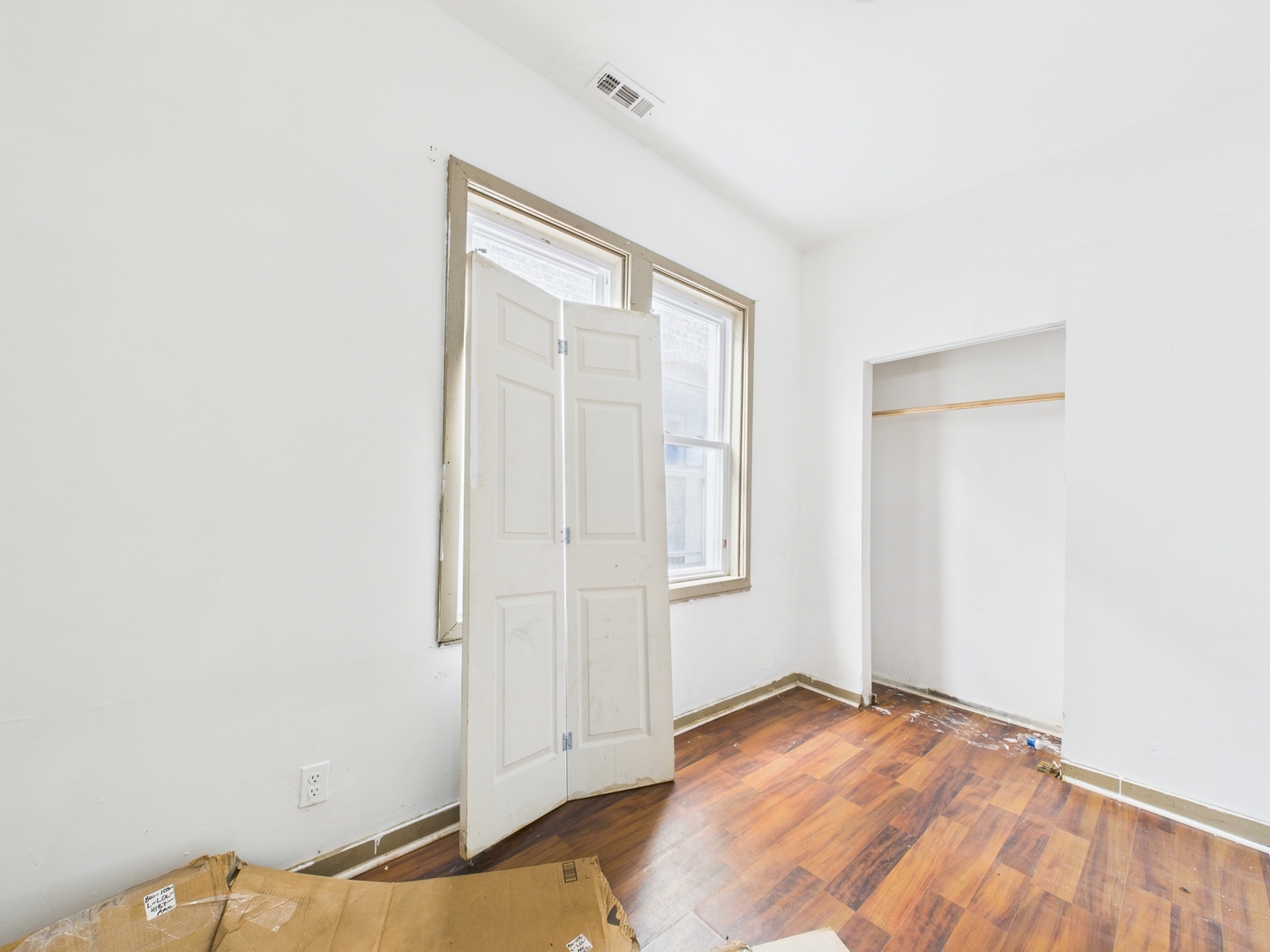 8709 South Escanaba Avenue Chicago, IL 60617 - Photo 12 of 31 an empty room with wooden floor and windows