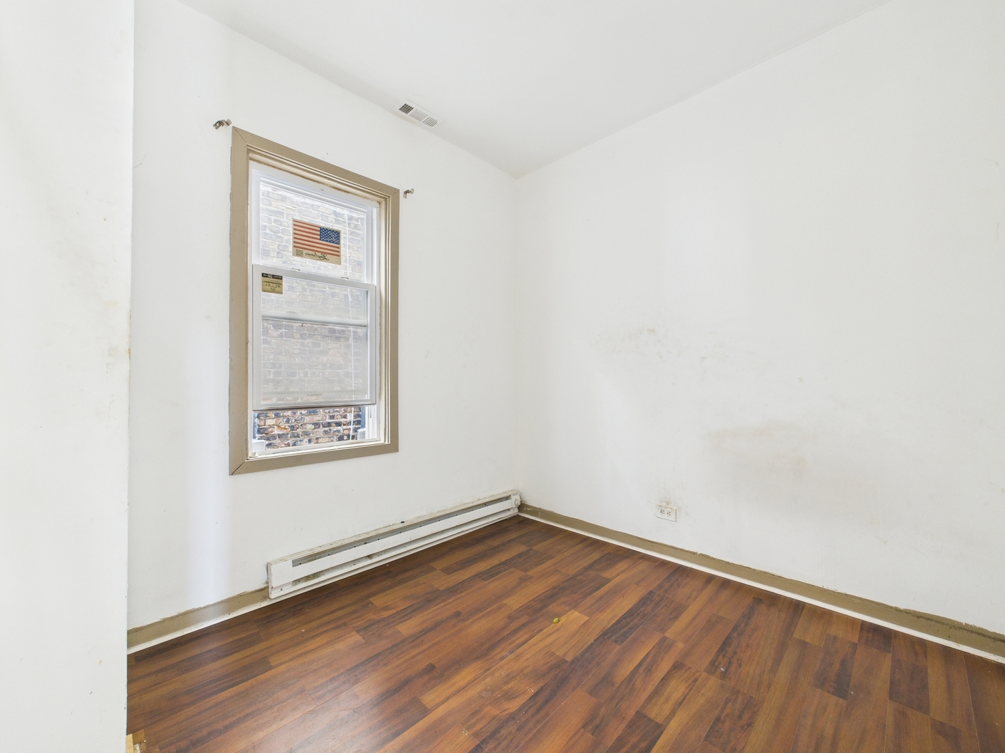 8709 South Escanaba Avenue Chicago, IL 60617 - Photo 18 of 31 a view of a room with wooden floor and white walls