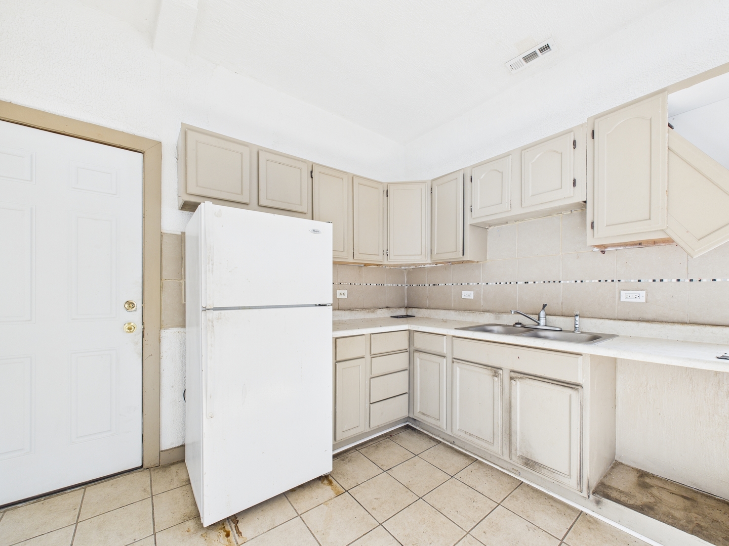 8709 South Escanaba Avenue Chicago, IL 60617 - Photo 21 of 31 a kitchen with white cabinets and white refrigerator