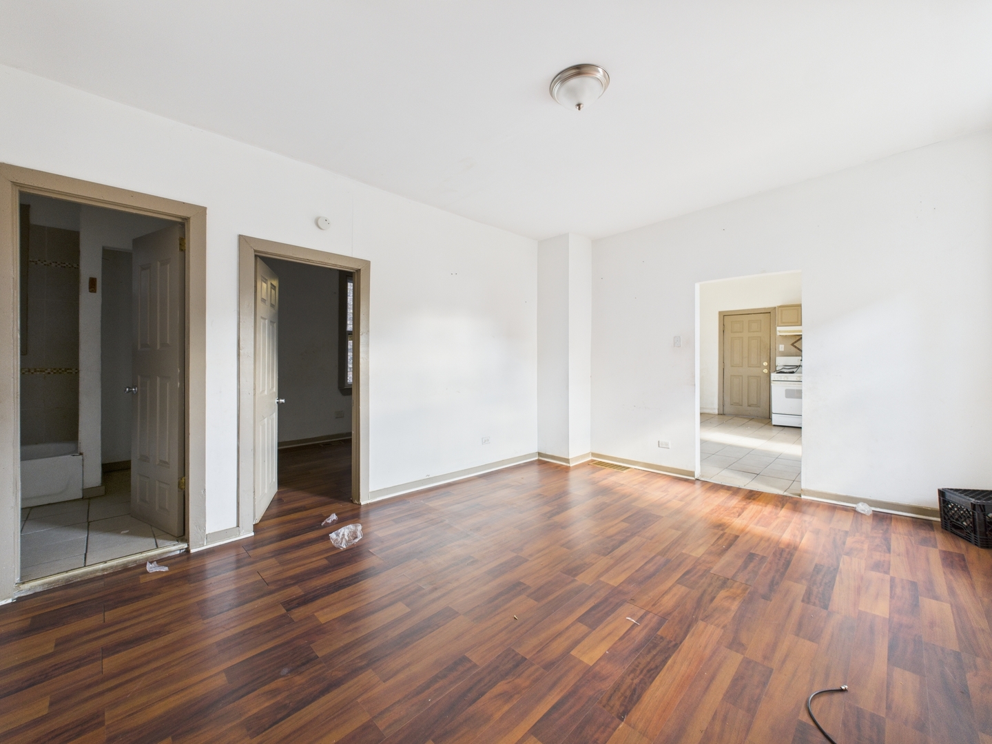 8709 South Escanaba Avenue Chicago, IL 60617 - Photo 22 of 31 a view of an empty room with wooden floor and a window