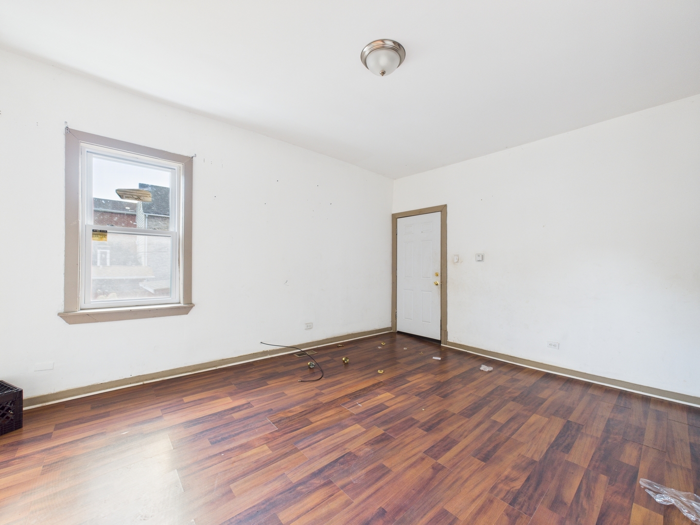 8709 South Escanaba Avenue Chicago, IL 60617 - Photo 23 of 31 an empty room with wooden floor and windows