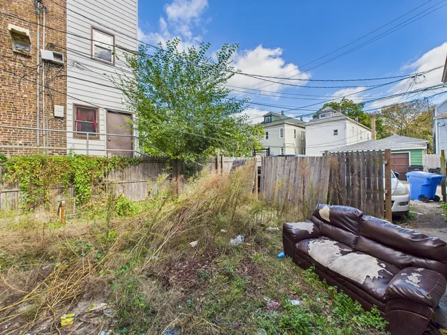 a view of a backyard with couches chair and wooden floor