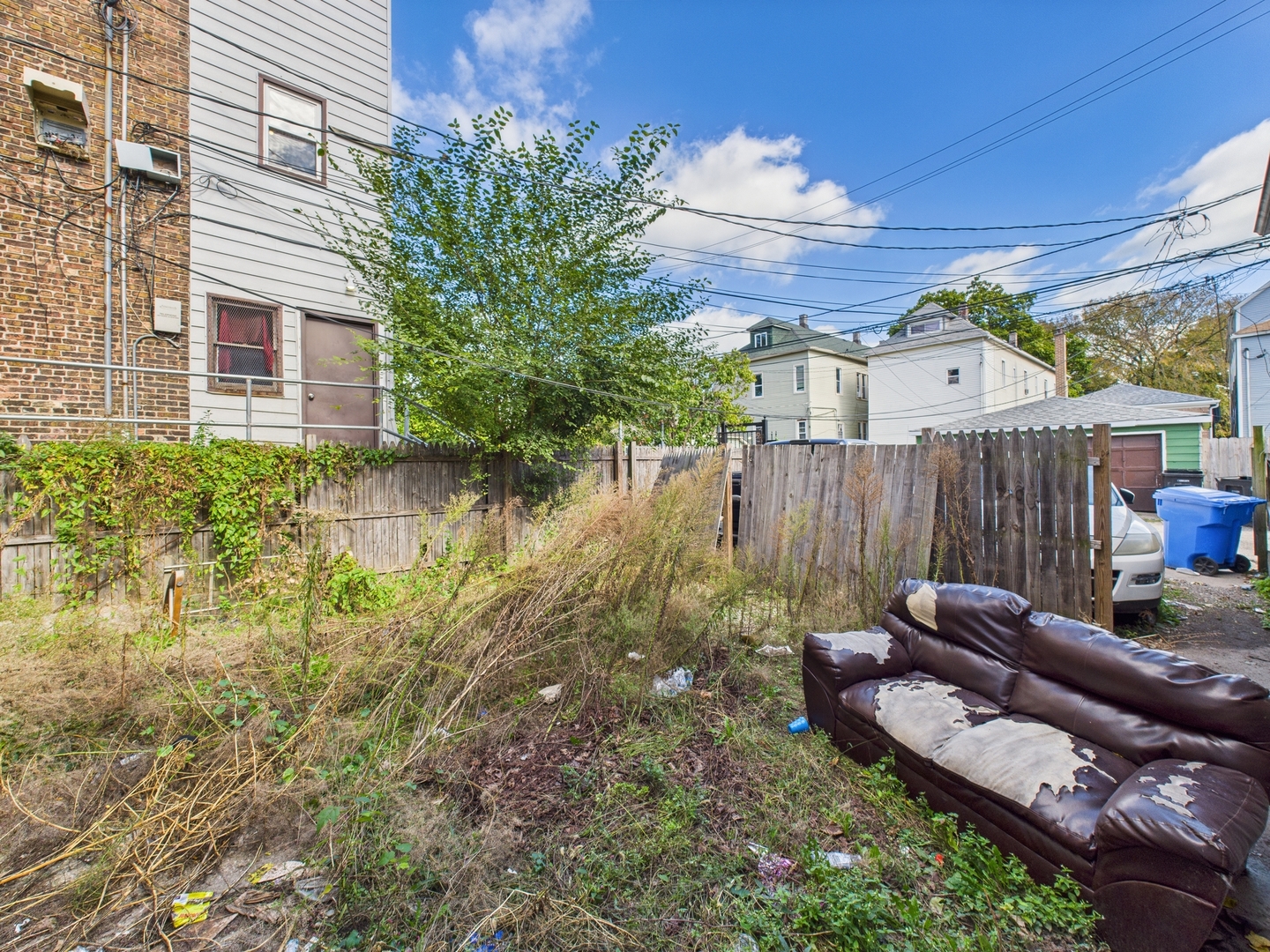 8709 South Escanaba Avenue Chicago, IL 60617 - Photo 30 of 31 a view of a backyard with couches chair and wooden floor