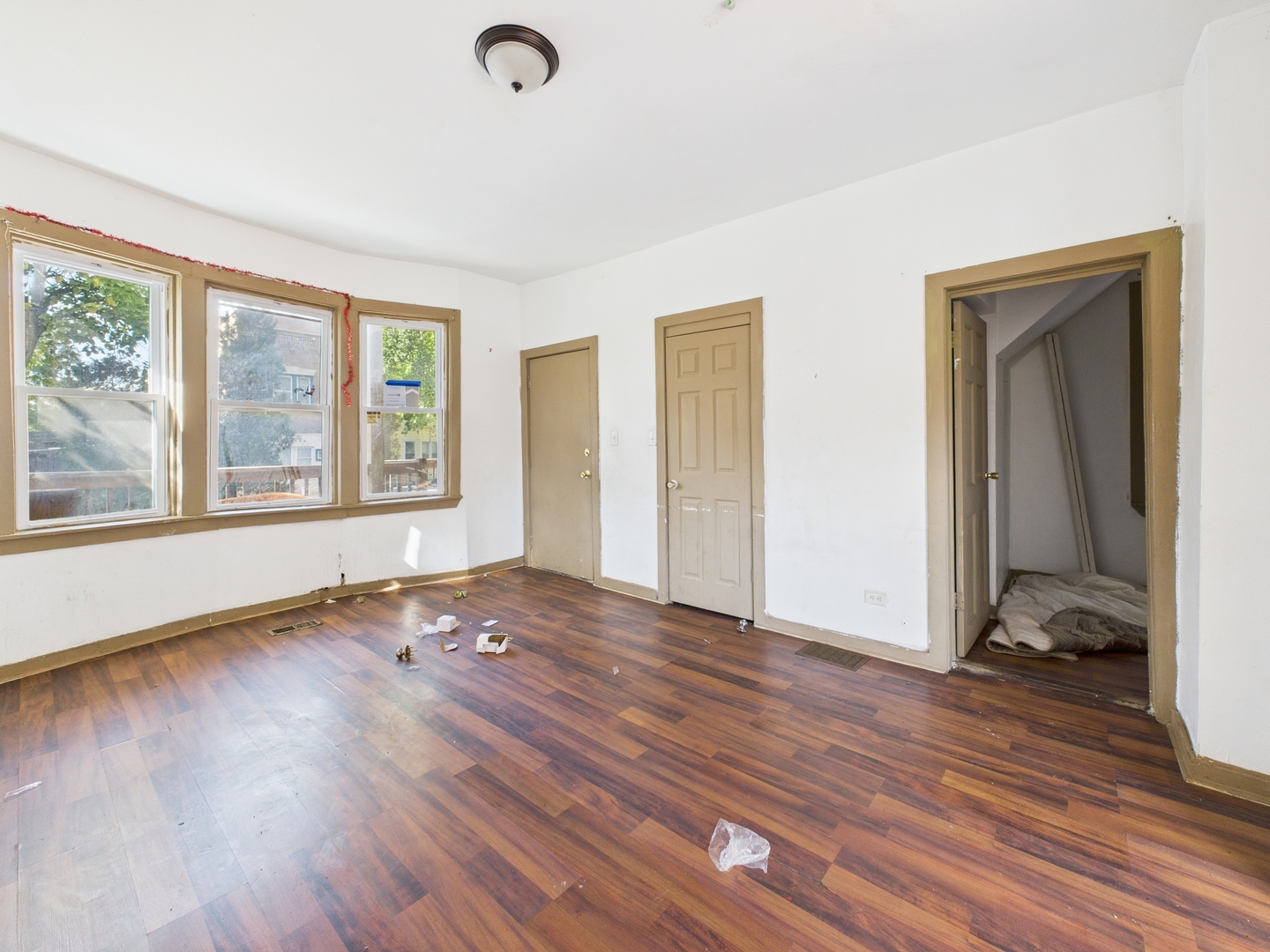 8709 South Escanaba Avenue Chicago, IL 60617 - Photo 3 of 31 an empty room with wooden floor and windows