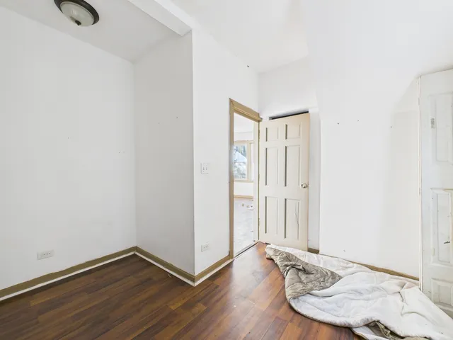 a view of a room with wooden floor and bathroom