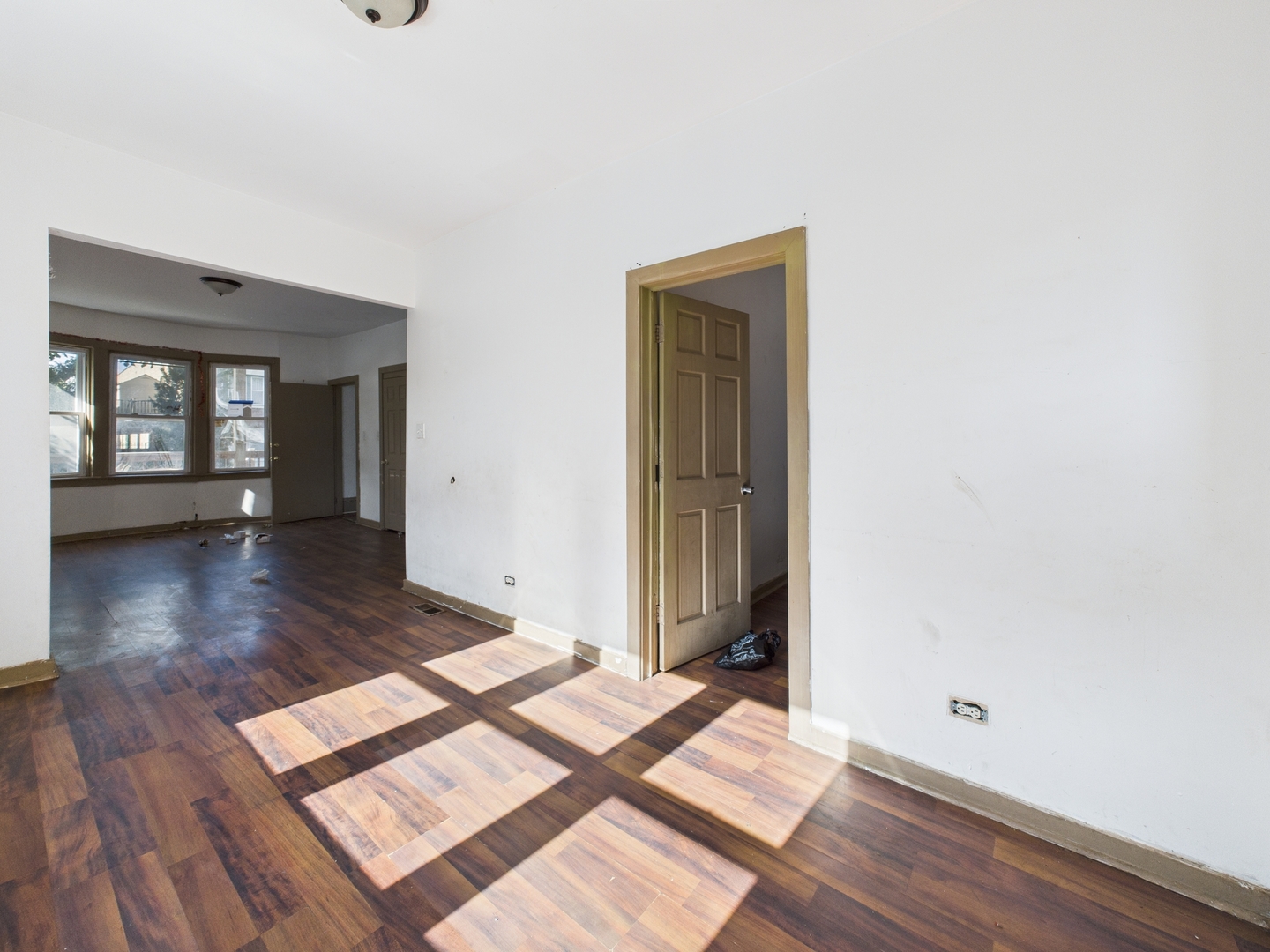 8709 South Escanaba Avenue Chicago, IL 60617 - Photo 6 of 31 a view of a room with wooden floor and a window
