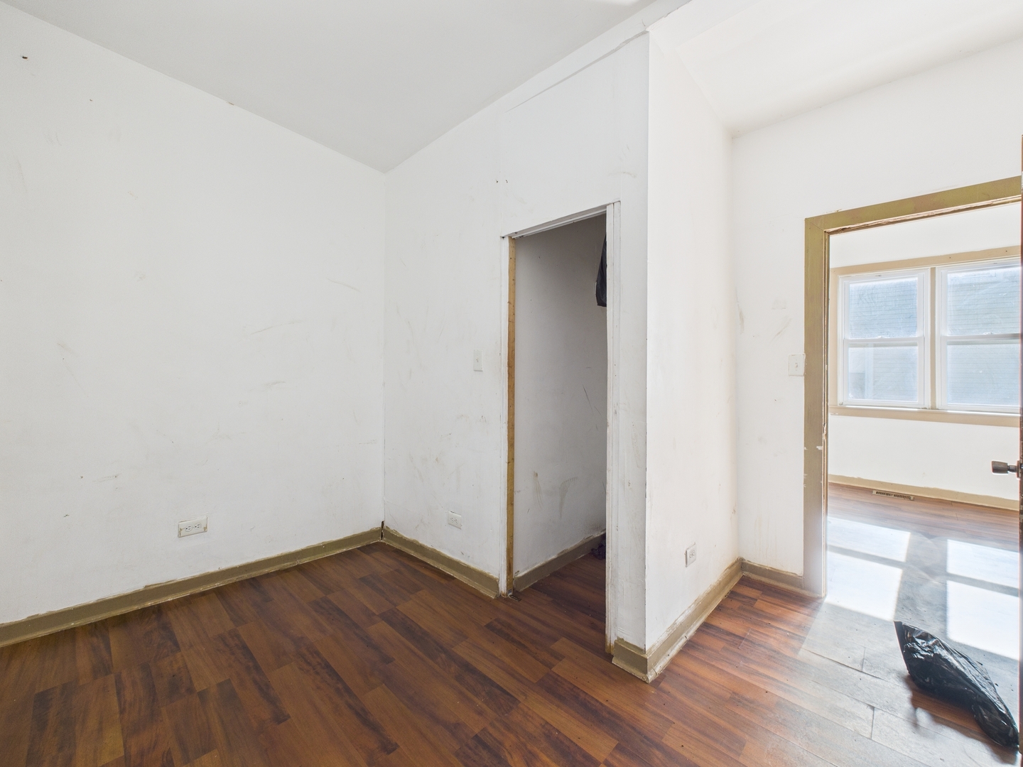 8709 South Escanaba Avenue Chicago, IL 60617 - Photo 8 of 31 an empty room with wooden floor and windows