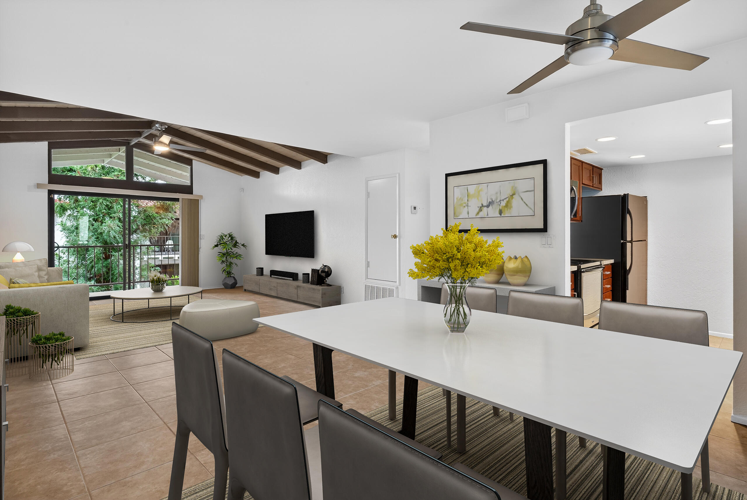 a kitchen with a table chairs refrigerator and microwave