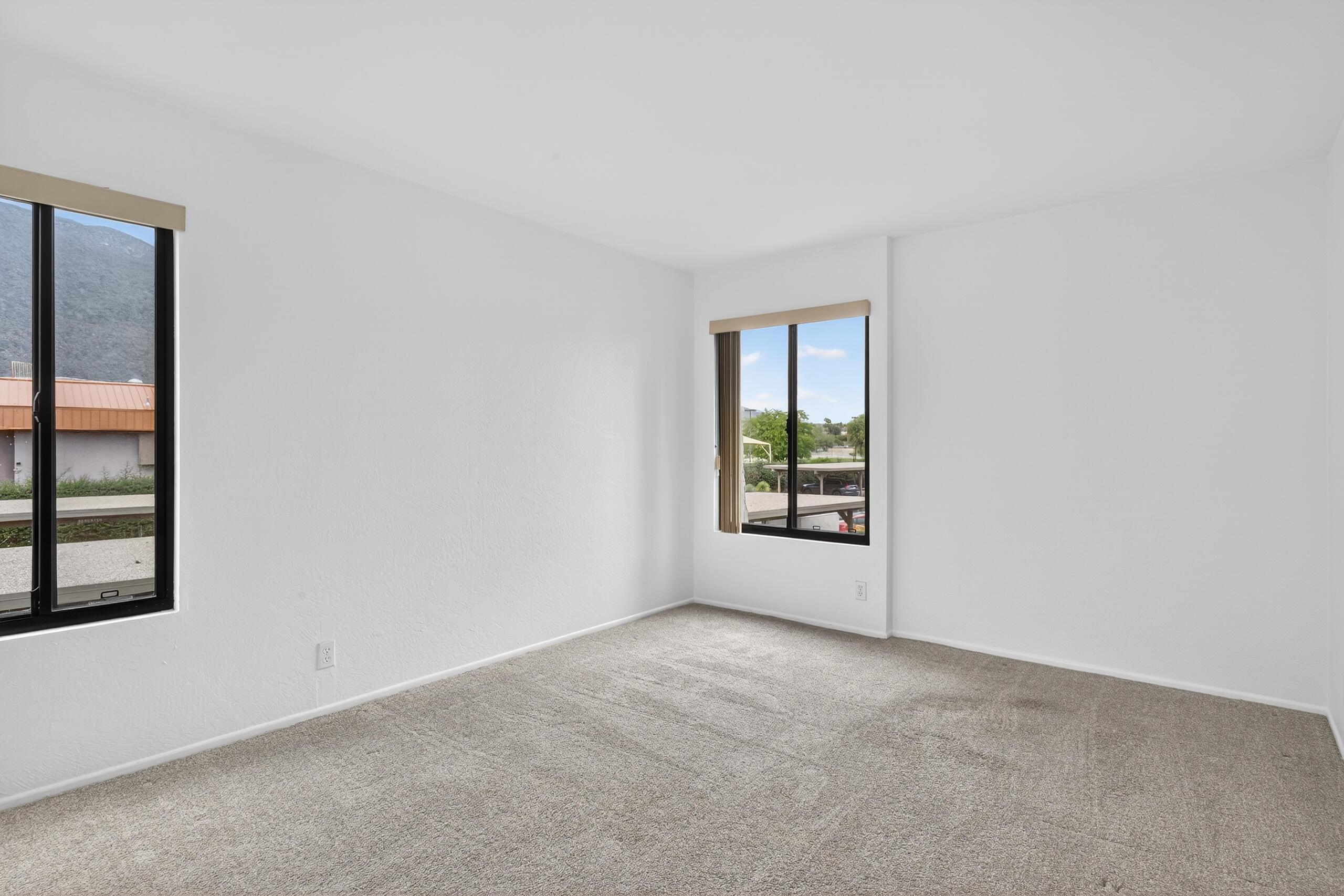 1050 Ramon Road, Unit 127 Palm Springs, CA 92264 - Photo 20 of 29 an empty room with windows