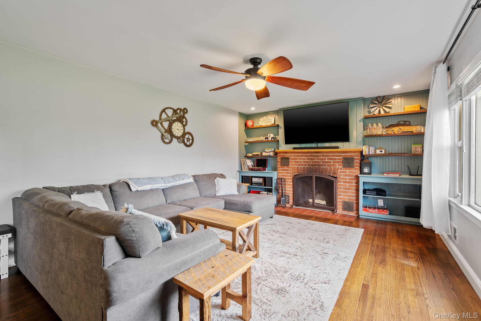 1327 County Rte 17 Montgomery, NY 12549 - Photo 12 of 37 a living room with furniture a fireplace and a flat screen tv